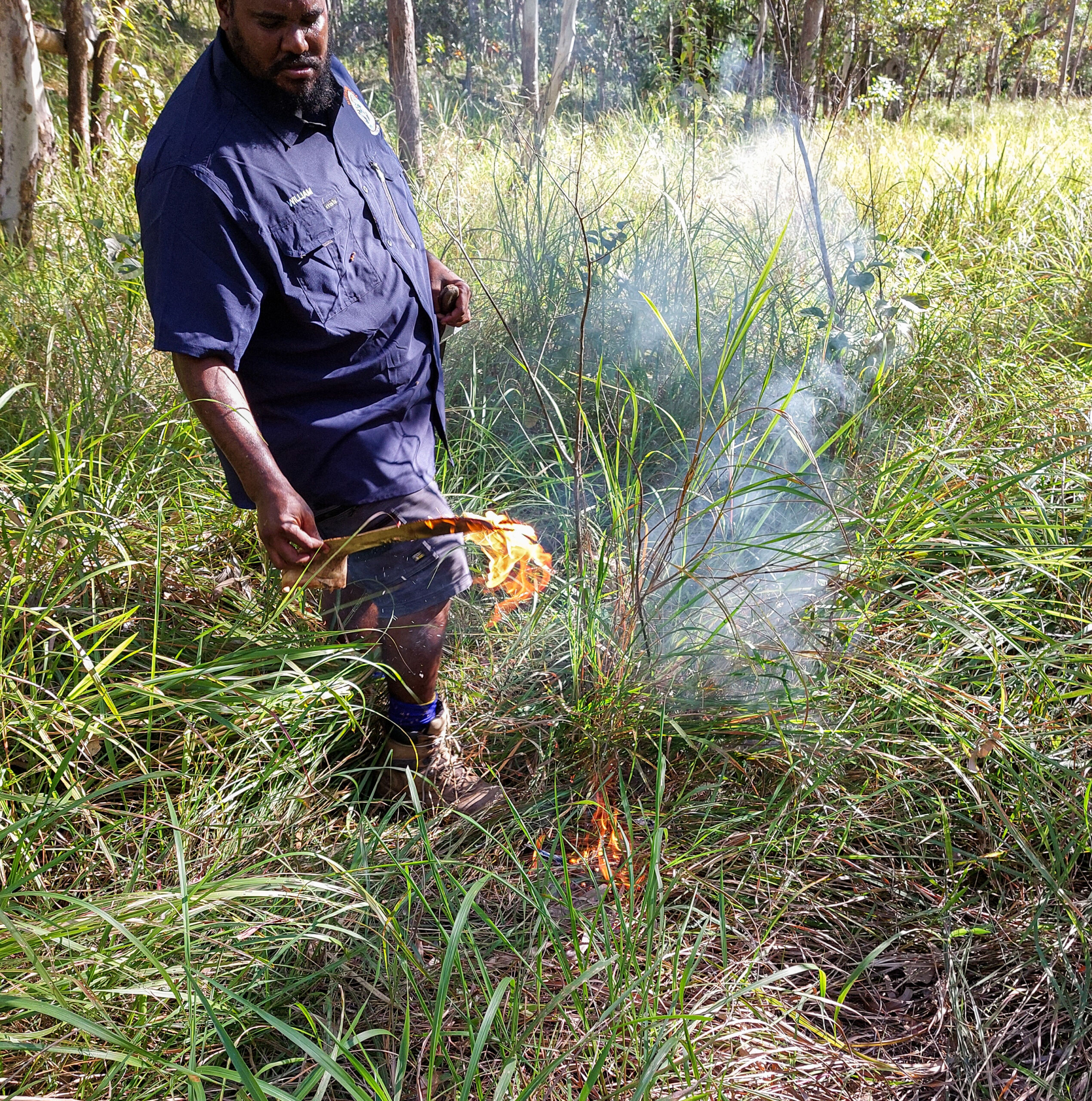 Aboriginal ranger doing some back burning in the bush.