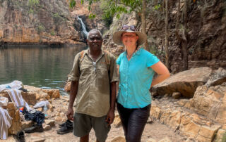 Senior Consultant Tracey Diddams and newly appointed specialist First Nations Tourism partner Victor Cooper, smiling in front of the picturesque Kakadu National Park.