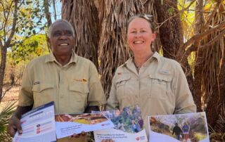 On the left Victor Cooper, First Nations Tourism Consultant and Director of Ayal Aboriginal Tours Kakadu, and next to him stands TRC Senior Consultant Tracey Diddams. They are pictured presenting the NT Aboriginal Cultural Tourism Framework.