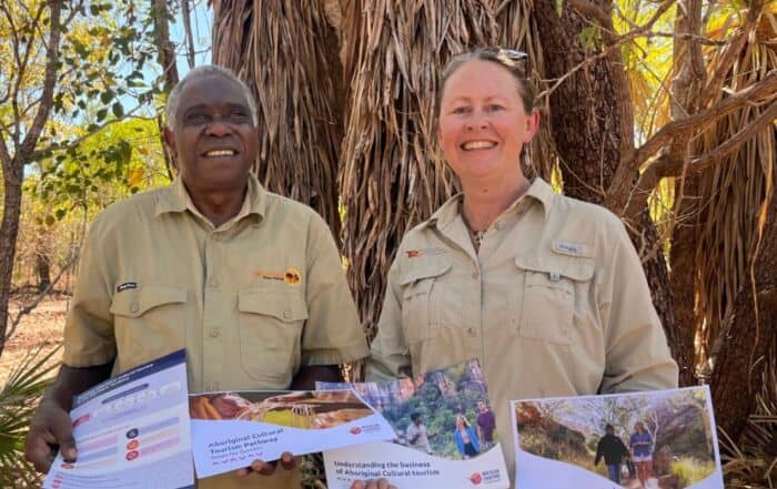 On the left Victor Cooper, First Nations Tourism Consultant and Director of Ayal Aboriginal Tours Kakadu, and next to him stands TRC Senior Consultant Tracey Diddams. They are pictured presenting the NT Aboriginal Cultural Tourism Framework.